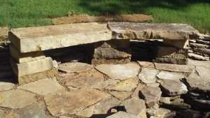 cut hardscape stone bench makes great outdoor fire pit seating