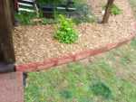 scalloped red cement garden bed