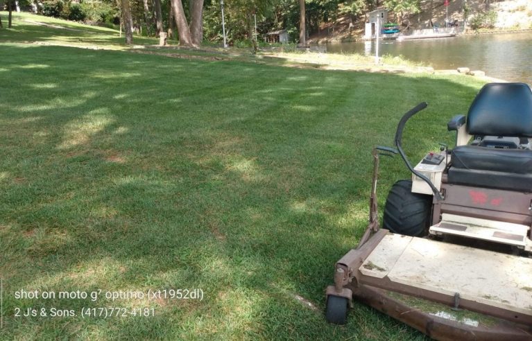 commercial mower on mow job, spring lawn clean up and mowing service
