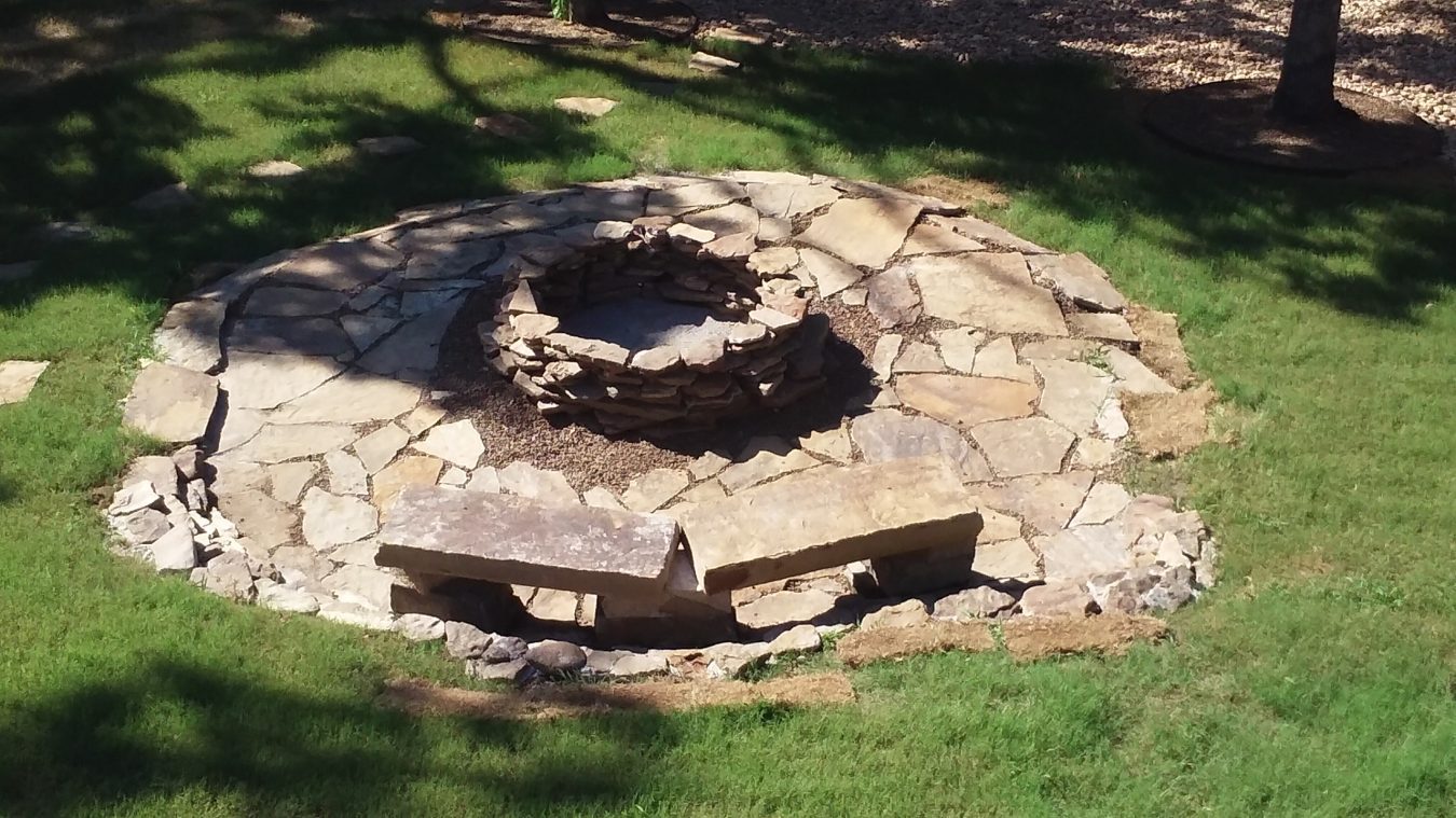 native stone firepit and bench, landscaping services